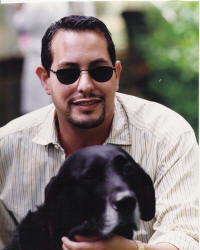 A man with sunglasses and a dog